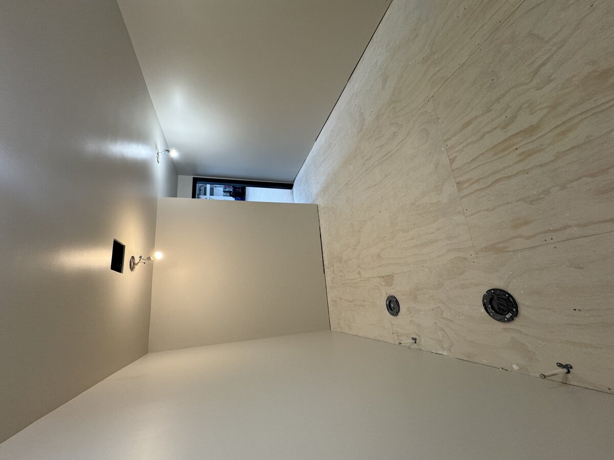 Commercial bathroom after paint, finished two-tone grey walls