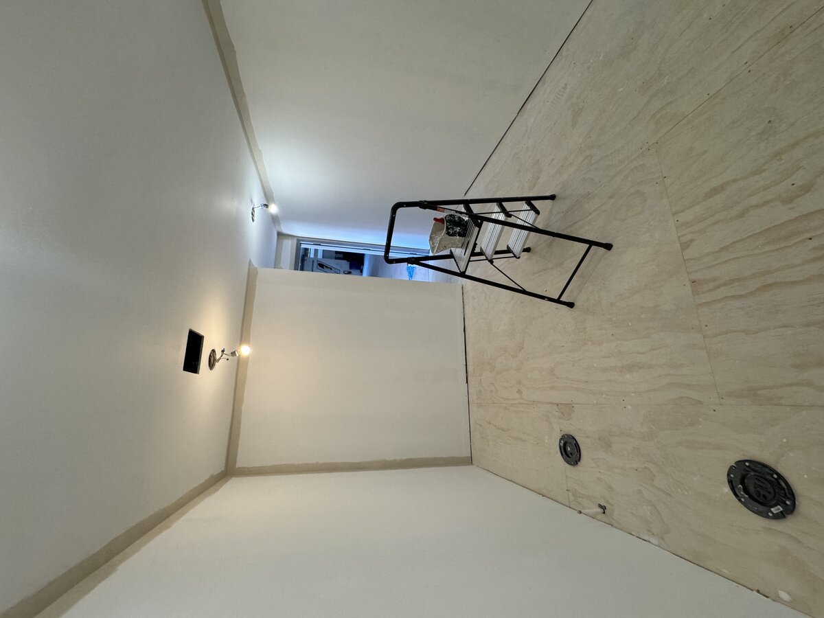 Commercial bathroom before paint, raw drywall and primer